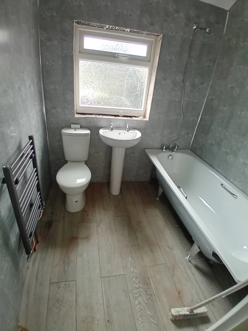 Full bathroom refit with bath, basin and heated towel rail